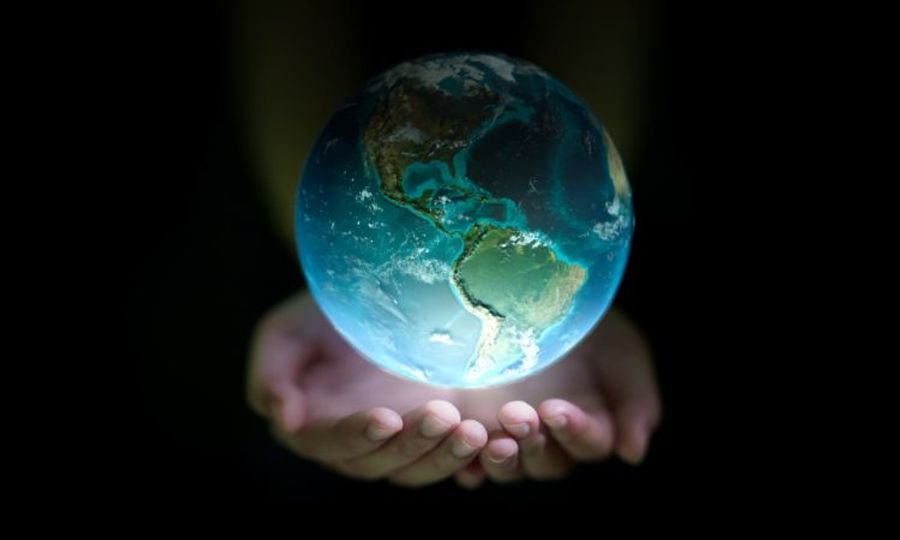 the earth floating above two hands